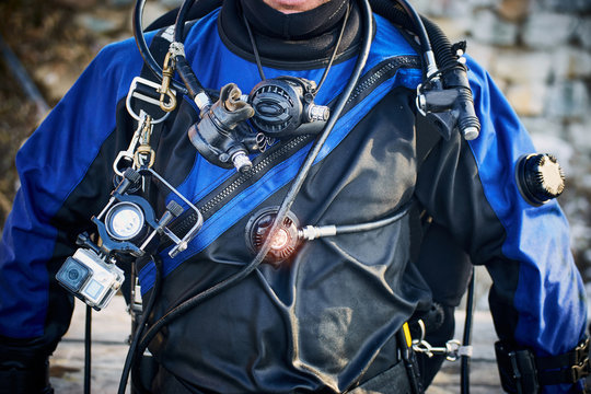 Submersion under water with balloons outfit in flippers and a mask.