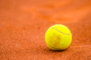 Tennis ball on a tennis clay court