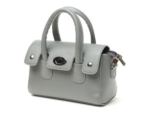 The photograph shows a female handbag on a white background