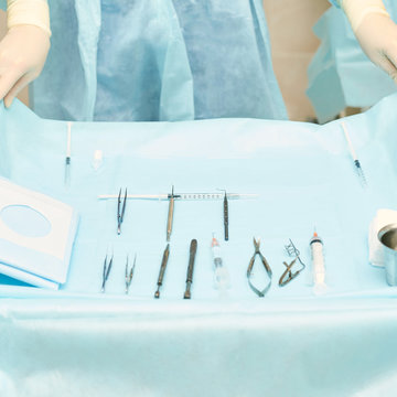 Ophthalmology laser microscope operation. Clinic room with doctor and parient. Gloves and medicine tools