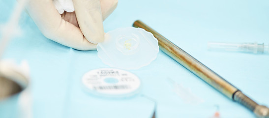 Ophthalmology laser microscope operation. Clinic room with doctor and parient. Gloves and medicine tools