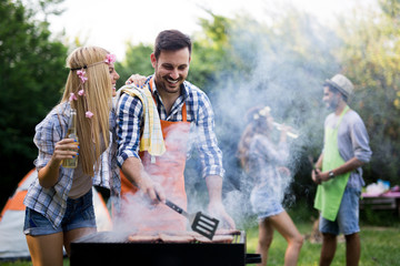 Friends having a barbecue party in nature