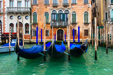 Fototapeta na wymiar Venice, Italy. Gondolas in Grand Canal near old house. Venice Down Town