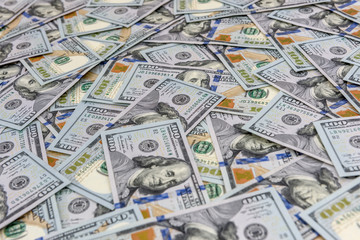 Fototapeta premium Background of many american one hundred dollar banknotes close up