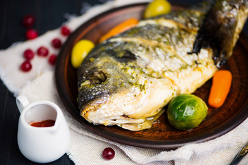 fried dorado fish with vegetables on a plate