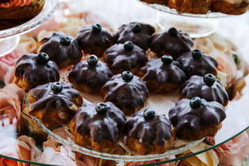 Cupcakes decorated with strawberries served on a banquet table.