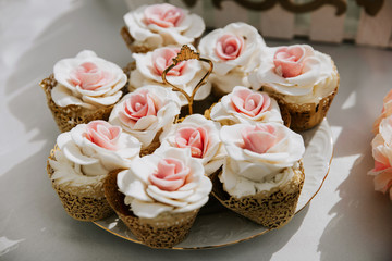 Pink cupcake stand on the white banquet table.