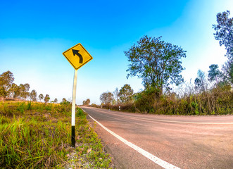 Curve to left sign on road