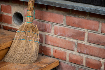 Old broom on the threshold of the house. Close up. Soft focus.