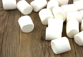 Mini fluffy white marshmallow on old wooden table