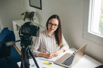 Girl blogger records video for their subscribers. Infobusiness or information business or hobby or...