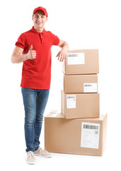 Delivery man with boxes showing thumb-up on white background