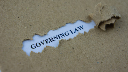 Torn paper with text governing law