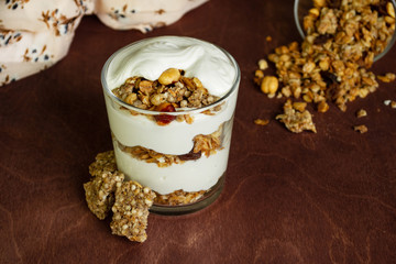 Healthy breakfast with granola and homemade yogurt in a glass. Rustic style
