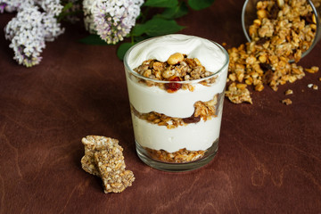 Healthy breakfast with granola and homemade yogurt in a glass. Rustic style