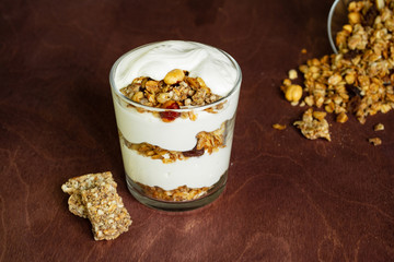 Healthy breakfast with granola and homemade yogurt in a glass. Rustic style