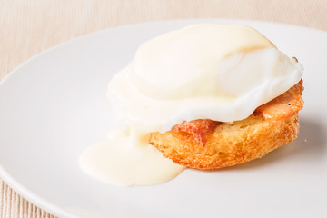 Breakfast is Eggs Benedict - toasted English muffins, bacon, ham, poached eggs, herbs and delicious buttery hollandaise sauce.