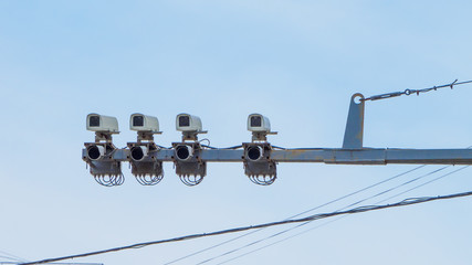 Modern speed control camera close-up on the background blue sky.