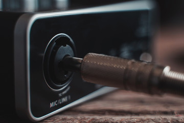 plugging a p10 cable into an audio interface