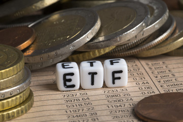 Exchange traded fund concept with ETF abbreviation near cash money 