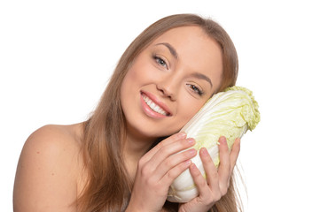 Portrait of a beautiful young woman with cabbages isolated