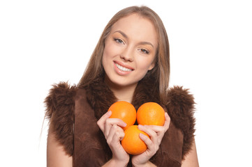 Portrait of young woman posing with oranges isolated