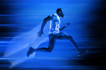 Fototapeta na wymiar Young african-american man running isolated on blue studio background. One male runner or jogger. Silhouette of jogging athlete with shadows in neon light. Movement or motion. Creative collage.