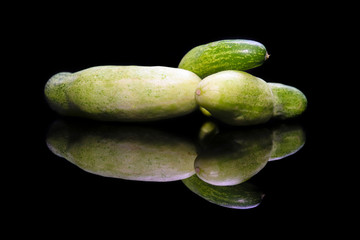 Cucumber isolated on black background and reflection