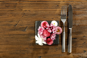 Fresh flowers and kitchen desk with fork 