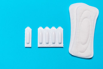 Medical, vaginal suppositories on a blue background, from candidiasis, thrush