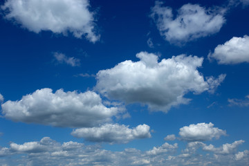 Fototapeta na wymiar Blue sky with perfect white fluffy clouds receding to horizon