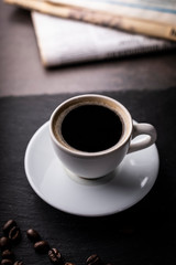 Black coffee in a cup, an aromatic hot drink.