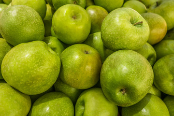 green apples on the counter on the market close up
