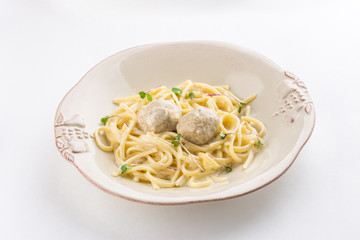 Pasta with meatballs on white plate isolated on white background