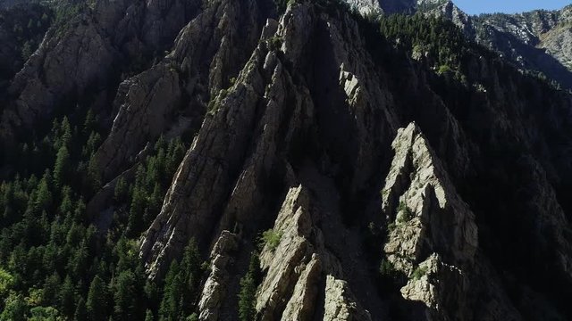 Aerial travelling shot above the granite cliffs in Big Cottonwood Canyon