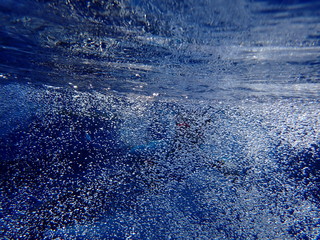 kid diving in water bubbles
