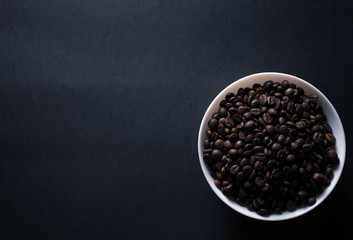 plate with coffee on black background with copy space