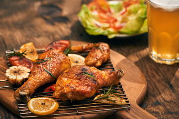 Hot and spicy chicken drumstick and wings closeup with beer