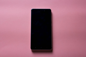 black mockup phone on pink background with copy space