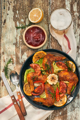 Grilled drumstick of chicken in spicy marinade with the addition of chili