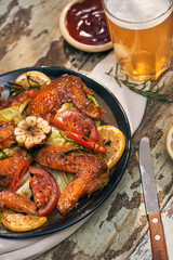 Grilled chicken wings spiced with chili peppers and rosemary