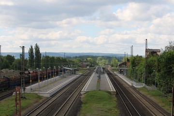 Fototapeta na wymiar Small town train station with platforms from above
