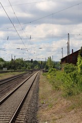 Fototapeta na wymiar Railroad track in the horizon with railway station parts