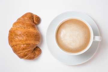 Breakfast coffee with croissants on a white background. Latte on a saucer