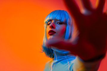 Futuristic female reaching out camera