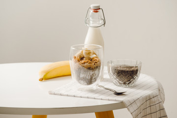 zBanana chia yogurt pudding decorated with ripe sliced banana and peanuts