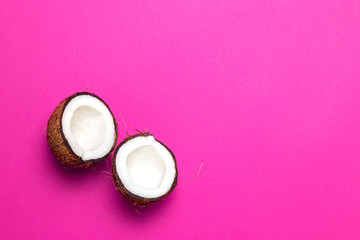 the halved coconut on pink background