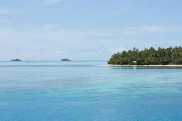 Several tropical islands with palm trees and huts in Tonga