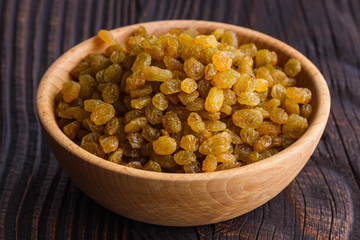 golden raisins on a wooden rustic background