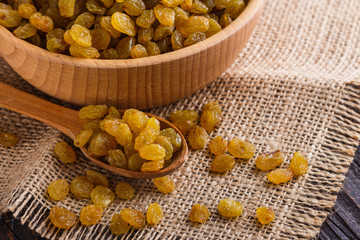 golden raisins on a wooden rustic background